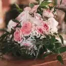 pink roses on brown wooden table