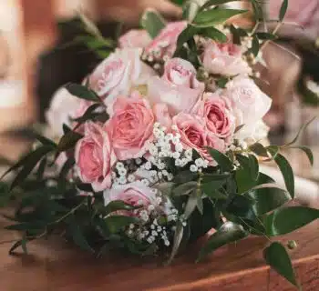 pink roses on brown wooden table